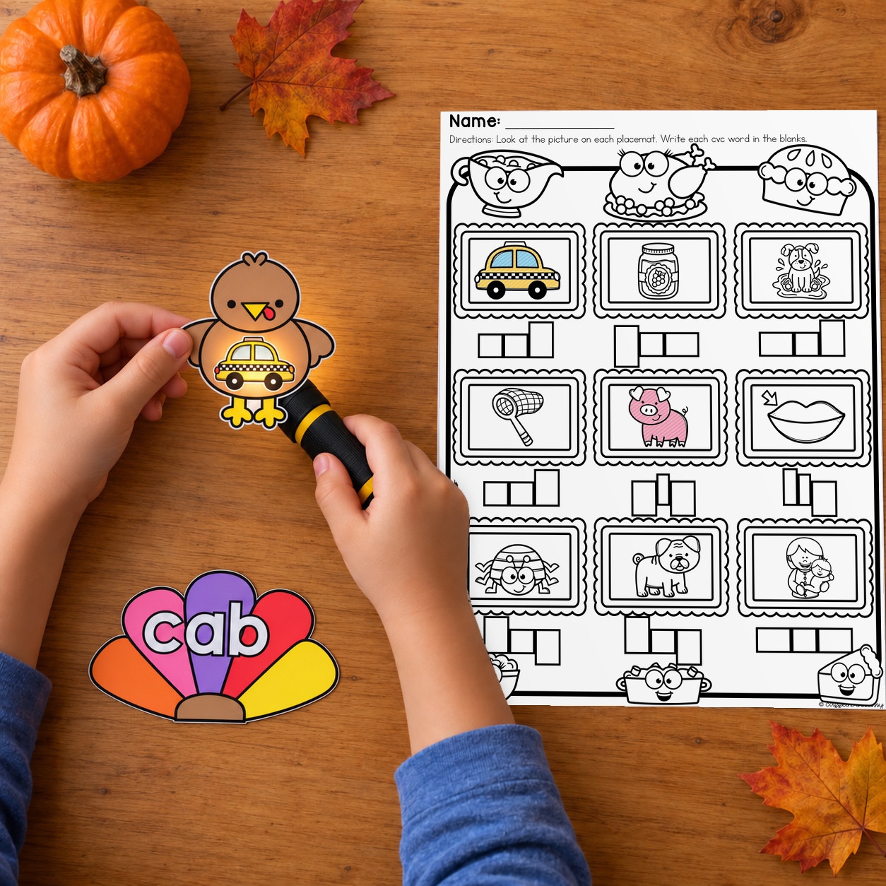 Flashlight reveals a cab picture beside a cab word tail and a Thanksgiving CVC writing page.